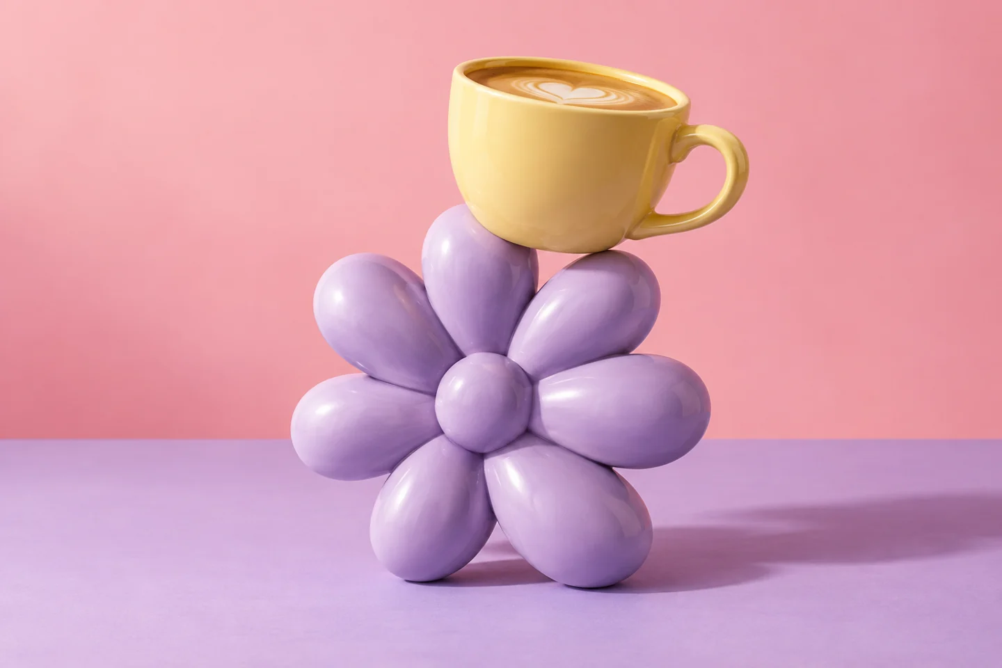 A butter-yellow coffee cup beside a sculptural lavender flower.